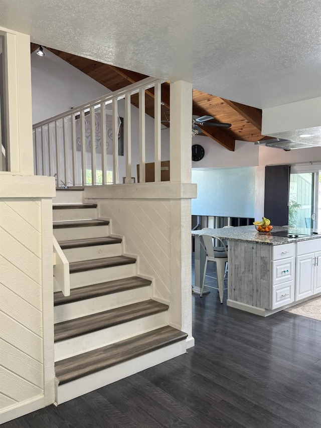 6762 N Knoll Ave, Fresno, CA 93711 - staircase featuring wood finished floors, a textured ceiling, and beam ceiling