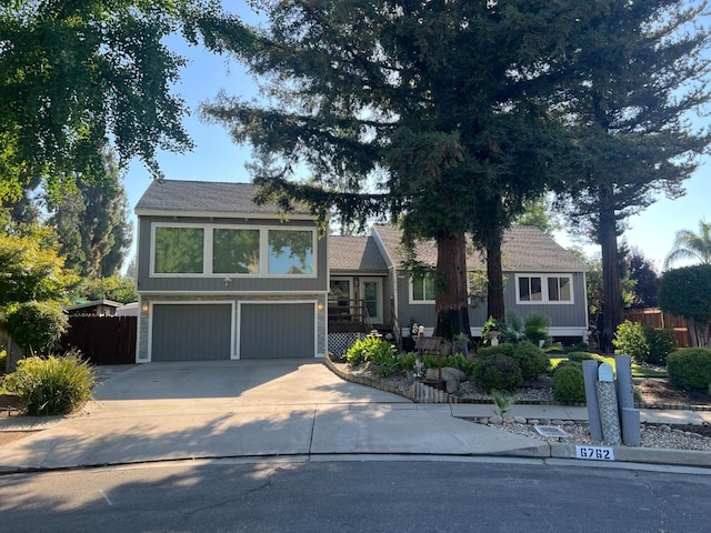 6762 N Knoll Ave, Fresno, CA 93711 - tri-level home featuring concrete driveway and a garage