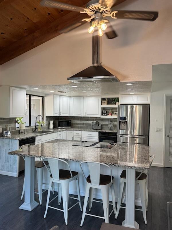 6762 N Knoll Ave, Fresno, CA 93711 - kitchen featuring appliances with stainless steel finishes, a sink, white cabinets, dark wood-style flooring, and wall chimney range hood