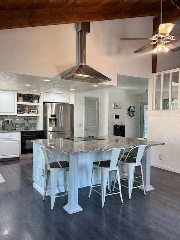 6762 N Knoll Ave, Fresno, CA 93711 - kitchen with black appliances, dark wood-type flooring, beam ceiling, white cabinetry, and wall chimney range hood
