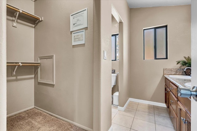 42939 Scenic Dr, Oakhurst, CA 93644 - bathroom with toilet, vanity, baseboards, and a spacious closet
