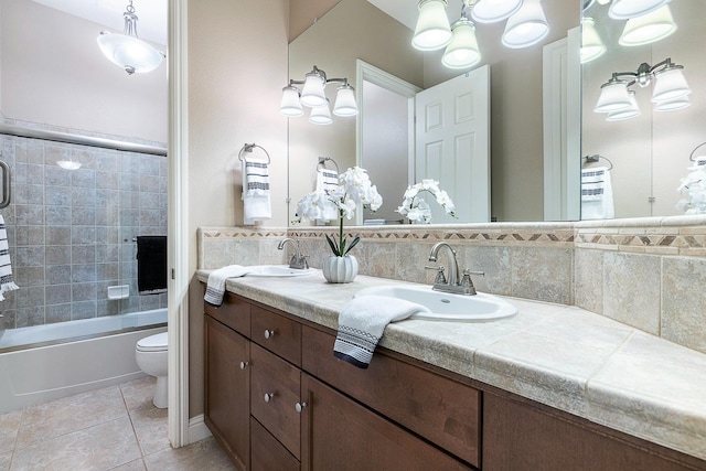 1977 N Dara Ave, Clovis, CA 93619 - full bathroom with toilet, double vanity, tile patterned floors, combined bath / shower with glass door, and tile walls