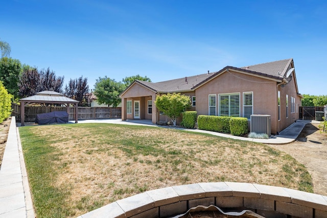1977 N Dara Ave, Clovis, CA 93619 - view of front facade featuring a gazebo, a patio area, central AC unit, and stucco siding