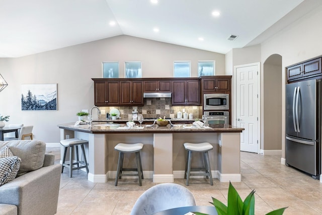 1977 N Dara Ave, Clovis, CA 93619 - kitchen with stainless steel appliances, under cabinet range hood, a breakfast bar, a sink, and lofted ceiling