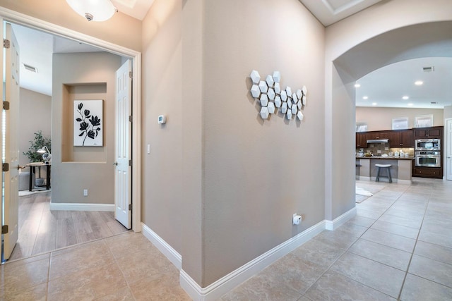 1977 N Dara Ave, Clovis, CA 93619 - corridor featuring arched walkways, light tile patterned floors, and recessed lighting