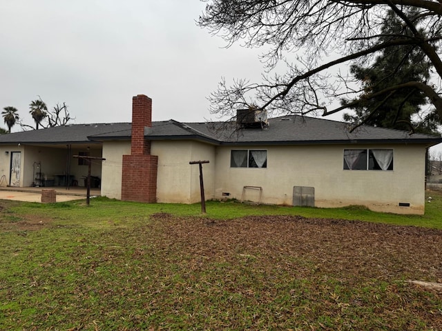 4167 W Shields Ave, Fresno, CA 93722 - rear view of house with a patio area, stucco siding, crawl space, a lawn, and a chimney