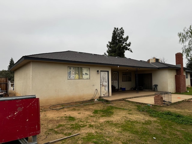 4167 W Shields Ave, Fresno, CA 93722 - back of house with a patio, stucco siding, and a chimney