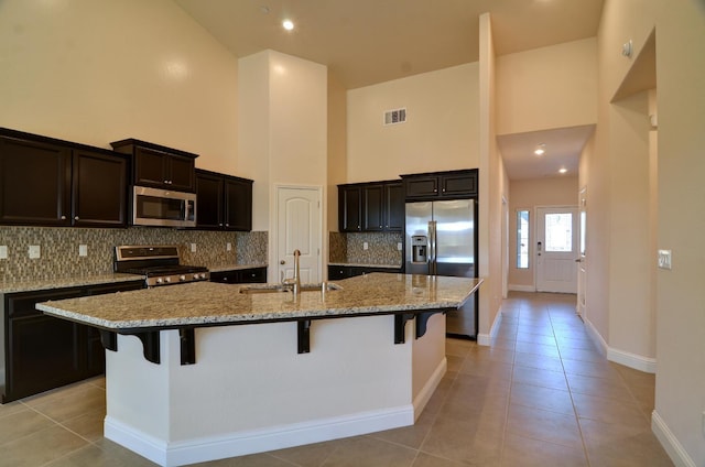 2129 La Canada Ave, Clovis, CA 93619 - kitchen featuring appliances with stainless steel finishes, high vaulted ceiling, a sink, light tile patterned floors, and baseboards