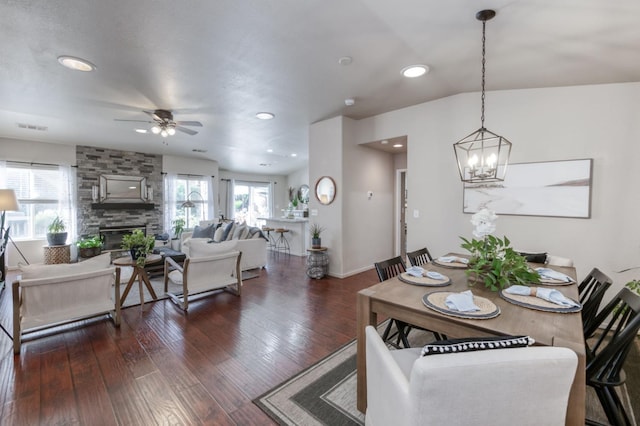 2602 E Pryor Dr, Fresno, CA 93720 - dining area with a stone fireplace, a ceiling fan, recessed lighting, a chandelier, and dark wood-type flooring