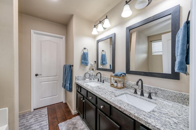 2602 E Pryor Dr, Fresno, CA 93720 - bathroom featuring double vanity, wood finished floors, and baseboards