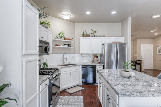 2602 E Pryor Dr, Fresno, CA 93720 - kitchen featuring black appliances, a sink, a center island, backsplash, and white cabinetry