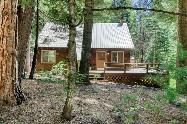 1140 Pine St, Fish Camp, CA 93623 - rustic home with a deck, metal roof, and a chimney