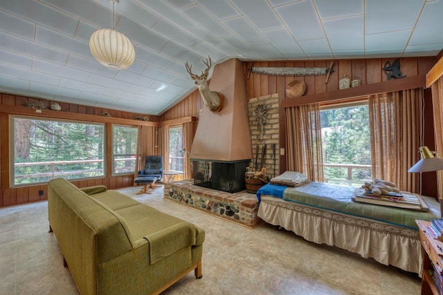 1140 Pine St, Fish Camp, CA 93623 - bedroom with wooden walls, vaulted ceiling, and a brick fireplace