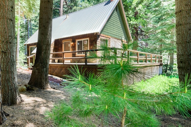 1140 Pine St, Fish Camp, CA 93623 - view of side of property with a deck and metal roof