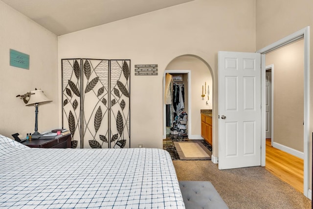 704 Rancho Vista Dr, Atwater, CA 95301 - carpeted bedroom featuring arched walkways, a walk in closet, baseboards, and a closet