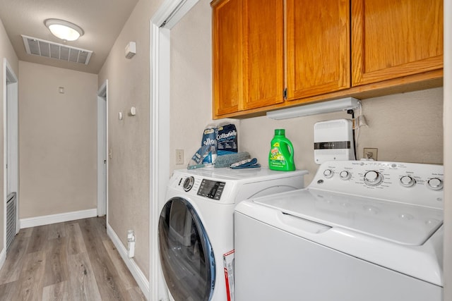 704 Rancho Vista Dr, Atwater, CA 95301 - laundry area featuring cabinet space, washer and dryer, light wood-style floors, and baseboards