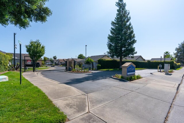 704 Rancho Vista Dr, Atwater, CA 95301 - view of road featuring a gate, a residential view, sidewalks, and a gated entry