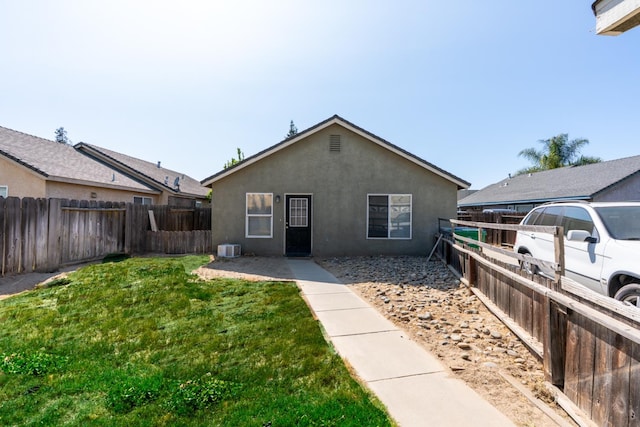 704 Rancho Vista Dr, Atwater, CA 95301 - back of property with stucco siding and central air condition unit