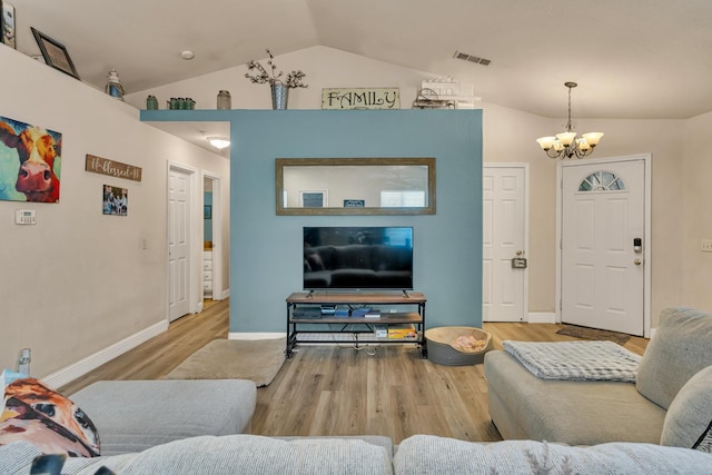 704 Rancho Vista Dr, Atwater, CA 95301 - living room featuring vaulted ceiling, a chandelier, wood finished floors, and baseboards