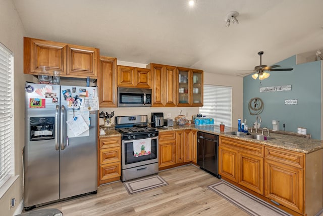 704 Rancho Vista Dr, Atwater, CA 95301 - kitchen featuring appliances with stainless steel finishes, a sink, brown cabinetry, a peninsula, and a ceiling fan