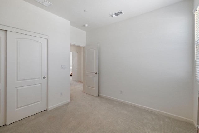 560 Overstone Ave, Madera, CA 93636 - unfurnished bedroom with light carpet, baseboards, and a closet