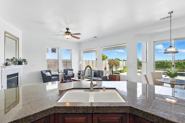 2721 Stuart Ave, Clovis, CA 93611 - kitchen with a sink, open floor plan, healthy amount of natural light, and a tiled fireplace