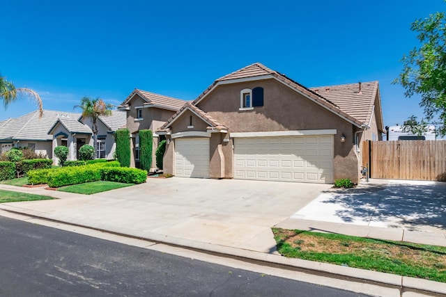 2721 Stuart Ave, Clovis, CA 93611 - view of front of home featuring stucco siding, a garage, driveway, and a tile roof