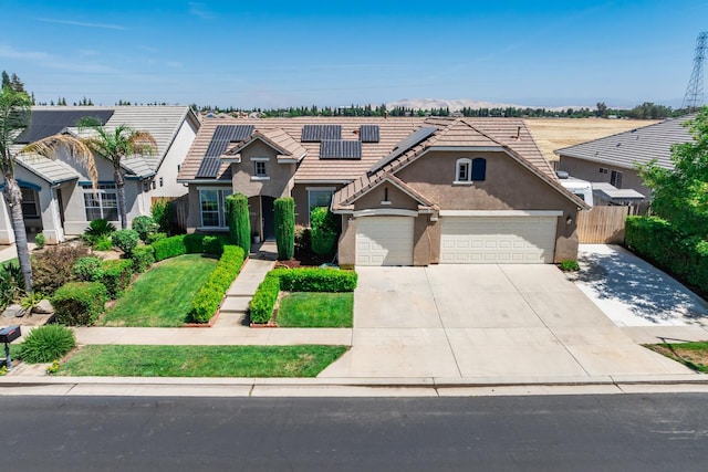 2721 Stuart Ave, Clovis, CA 93611 - traditional home with driveway, stucco siding, solar panels, a tile roof, and an attached garage
