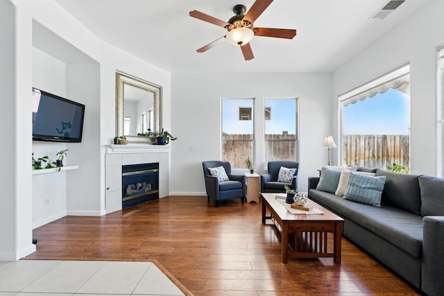 2721 Stuart Ave, Clovis, CA 93611 - living area featuring a ceiling fan, hardwood / wood-style floors, a fireplace, and baseboards