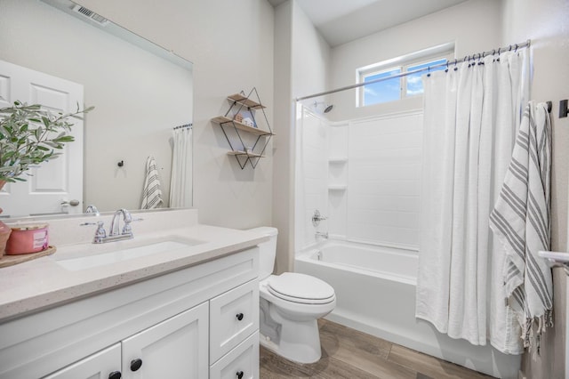 6085 E Homan Ave, Fresno, CA 93727 - full bathroom with toilet, vanity, shower / tub combo, and wood finished floors