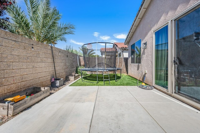 6085 E Homan Ave, Fresno, CA 93727 - fenced backyard with a trampoline and a patio area
