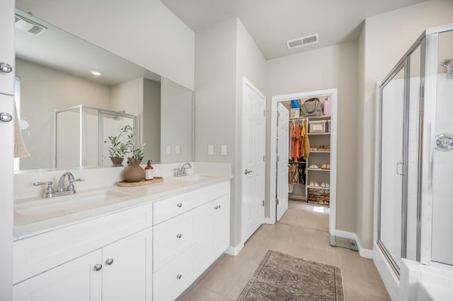 6085 E Homan Ave, Fresno, CA 93727 - bathroom with a shower stall, double vanity, and a walk in closet
