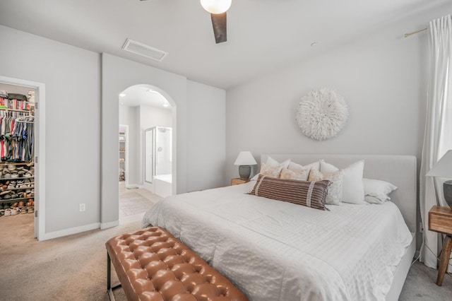 6085 E Homan Ave, Fresno, CA 93727 - bedroom with a walk in closet, arched walkways, carpet floors, a closet, and ensuite bath