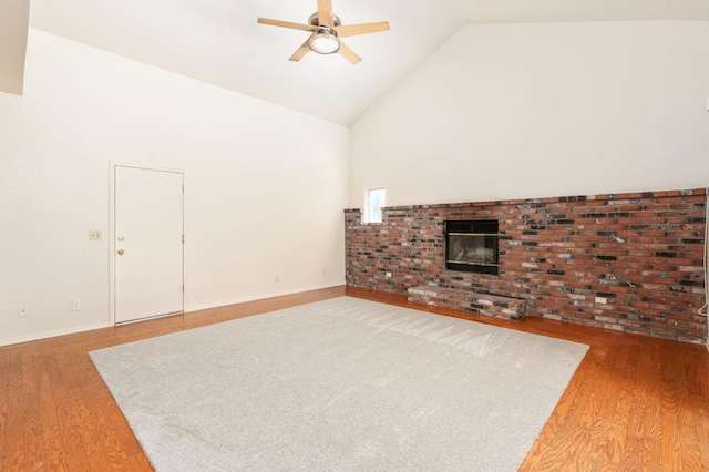 392 W Magill Ave, Clovis, CA 93612 - unfurnished living room with wood finished floors, ceiling fan, high vaulted ceiling, a brick fireplace, and baseboards