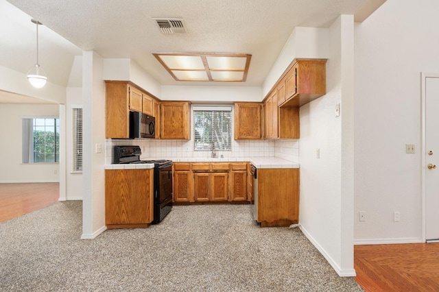 392 W Magill Ave, Clovis, CA 93612 - kitchen featuring black appliances, tile countertops, brown cabinets, a sink, and plenty of natural light