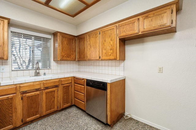 392 W Magill Ave, Clovis, CA 93612 - kitchen featuring stainless steel dishwasher, a sink, decorative backsplash, and brown cabinetry