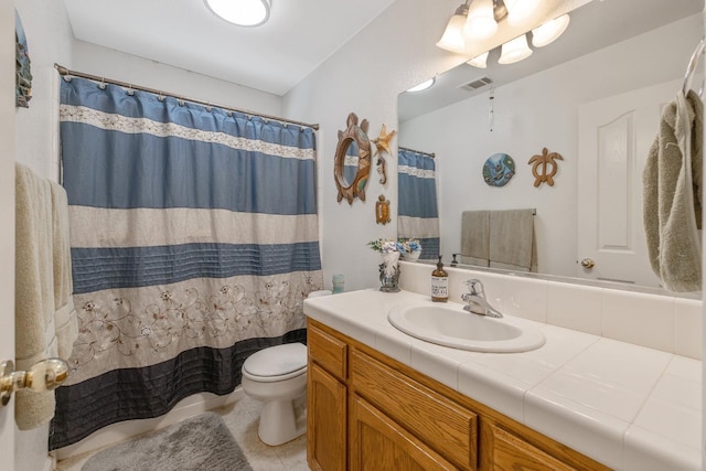8519 E Olive Ave, Fresno, CA 93737 - full bath featuring vanity, toilet, tile patterned floors, and a shower with curtain
