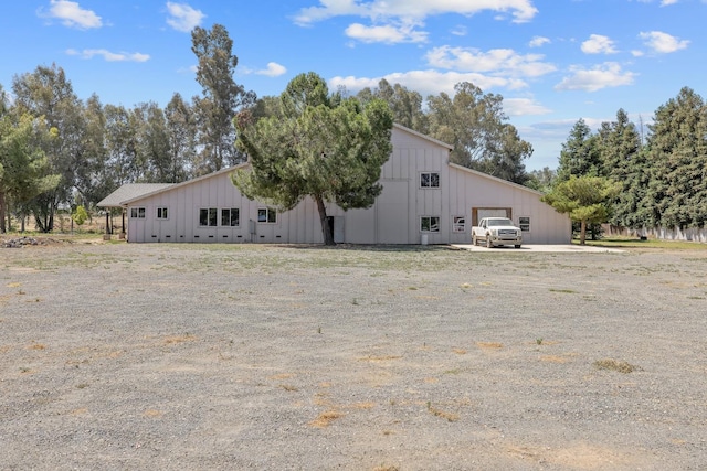 8519 E Olive Ave, Fresno, CA 93737 - view of side of property featuring board and batten siding, an outbuilding, and a garage
