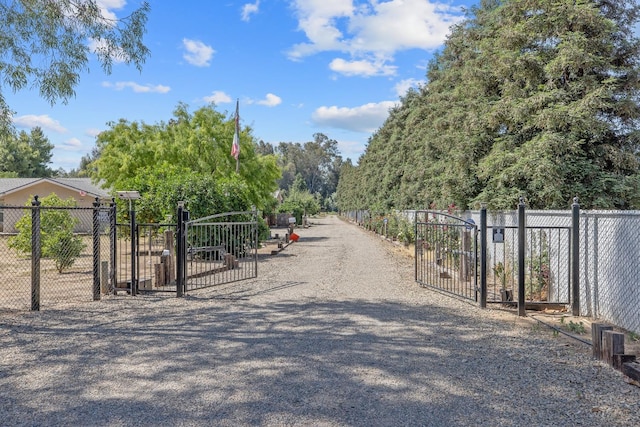 8519 E Olive Ave, Fresno, CA 93737 - view of dirt / gravel driveway featuring a gate and a gated entry
