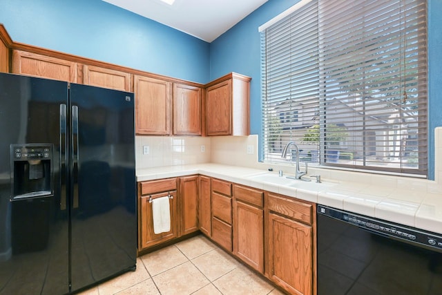 73 W Bordeaux Ln, Clovis, CA 93619 - kitchen with black appliances, a sink, decorative backsplash, and tile counters