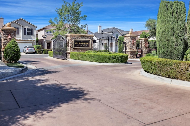 73 W Bordeaux Ln, Clovis, CA 93619 - view of concrete street featuring curbs, a gate, and a gated entry