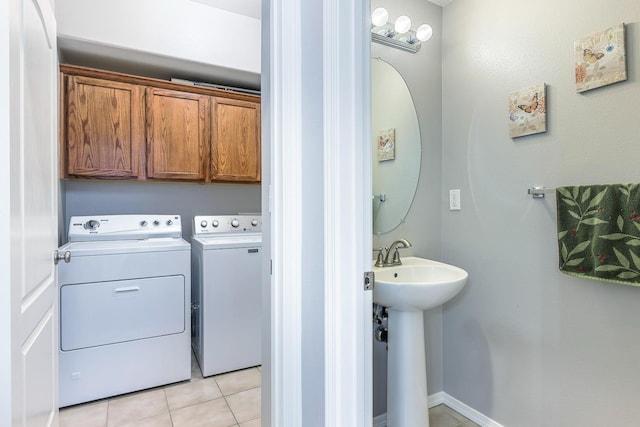 73 W Bordeaux Ln, Clovis, CA 93619 - laundry room featuring washing machine and clothes dryer, light tile patterned flooring, and cabinet space