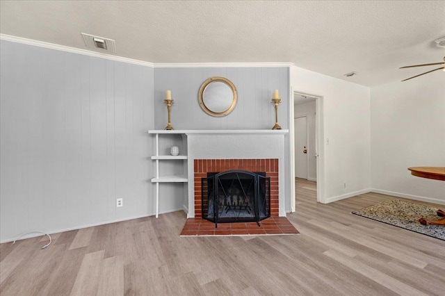 826 W Fedora Ave, Fresno, CA 93705 - living room with wood finished floors, a ceiling fan, baseboards, a textured ceiling, and a brick fireplace