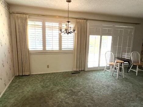 1320 Maple, Selma, CA 93662 - carpeted dining area featuring a textured ceiling and a chandelier