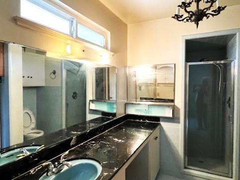 1320 Maple, Selma, CA 93662 - bathroom with a shower stall, double vanity, and a chandelier