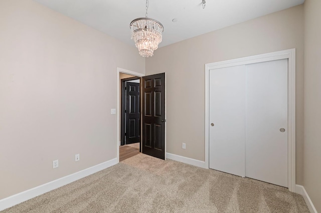 7374 E Flint Way, Fresno, CA 93737 - unfurnished bedroom featuring a chandelier, carpet flooring, baseboards, and a closet