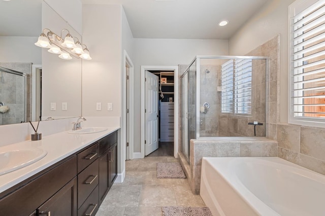 7374 E Flint Way, Fresno, CA 93737 - bathroom with a bath, a stall shower, double vanity, and a walk in closet