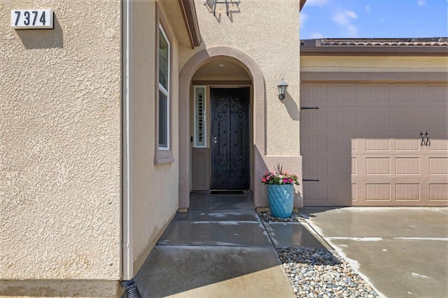 7374 E Flint Way, Fresno, CA 93737 - entrance to property with stucco siding, a garage, and driveway