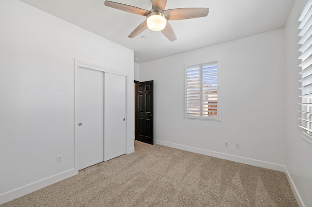 7374 E Flint Way, Fresno, CA 93737 - unfurnished bedroom featuring light colored carpet, baseboards, and a closet