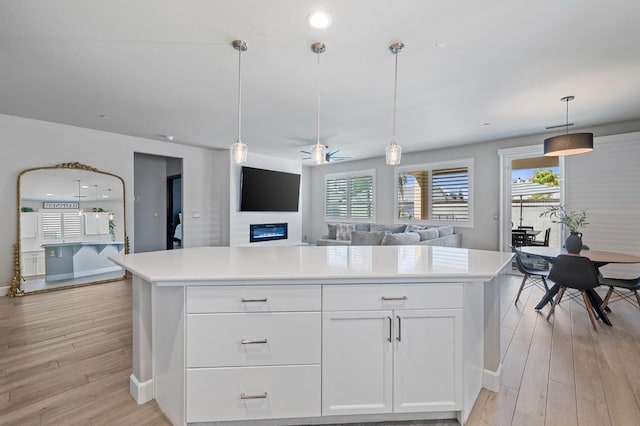 7374 E Flint Way, Fresno, CA 93737 - kitchen with light wood-style floors, light countertops, white cabinets, baseboards, and recessed lighting